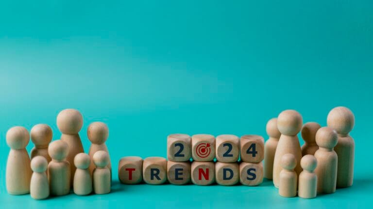 2024 Action Plan. Wooden figures of people and wooden cubes with the word Trends 2024